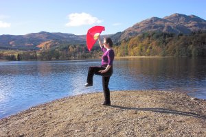 tai chi fan against Scottish loch